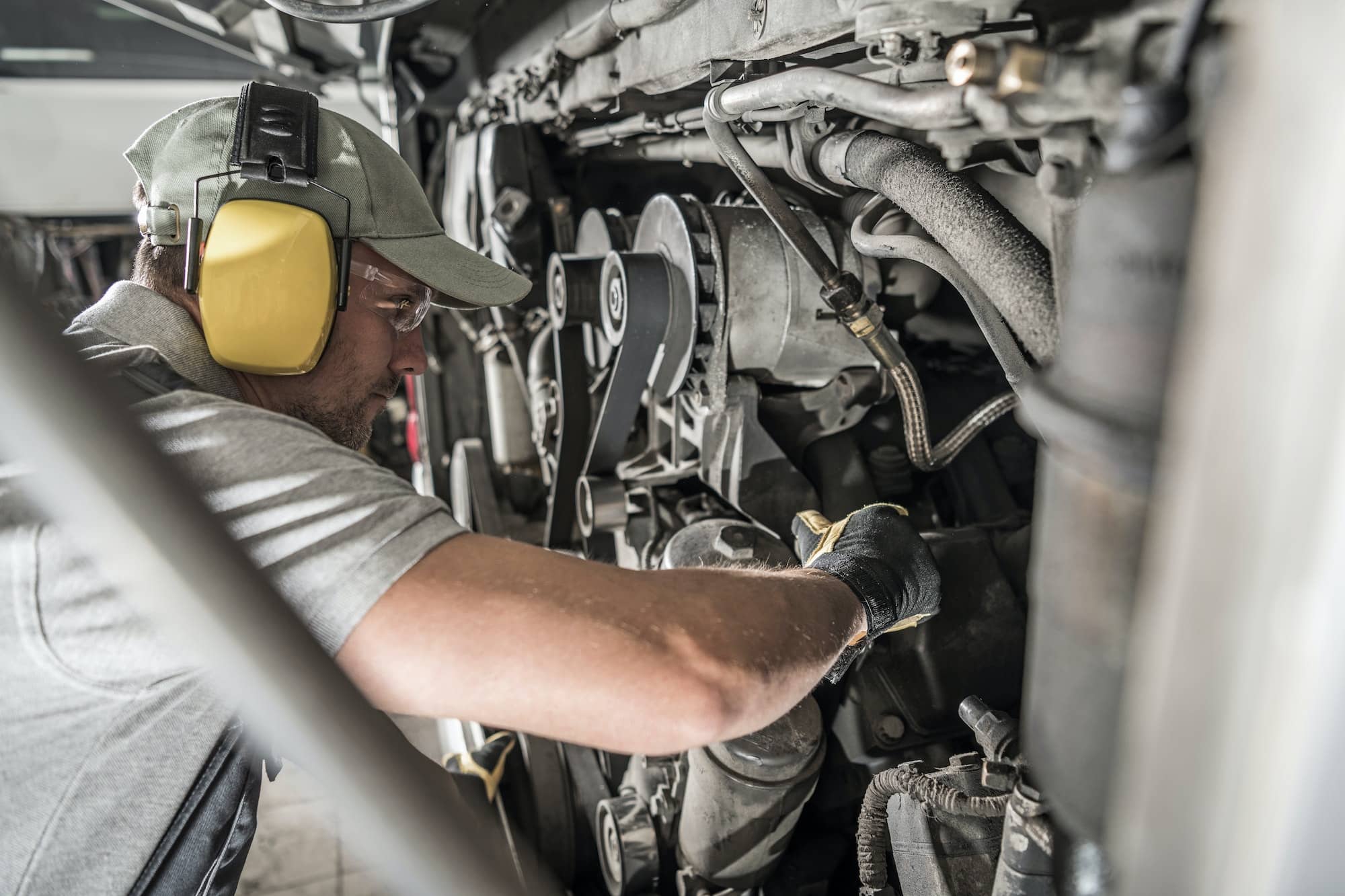 Automotive Mechanic Looking Inside Engine Compartment