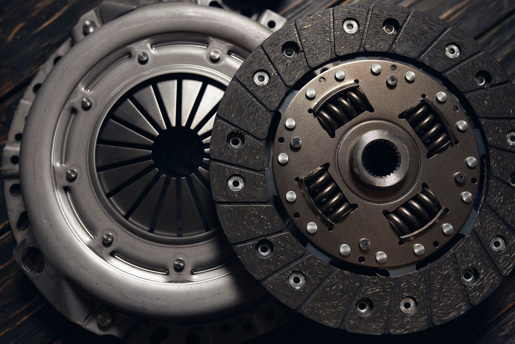 new car clutch kit on a dark wooden background. Close up